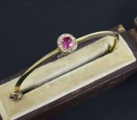A Victorian gold, ruby and diamond cluster hinged bangle, in original box.