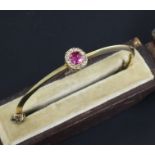 A Victorian gold, ruby and diamond cluster hinged bangle, in original box.