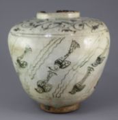 A Kashan pottery ovoid jar, 13th century, painted with stylised fish amid weed under a pale