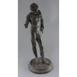 After the Antique. A Grand Tour bronze figure of Narcissus, standing on an integral circular plinth,