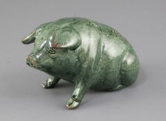 A Ewenny green glazed pottery model of a seated pig, its back inscribed 'Y.Mochyn', and incised mark