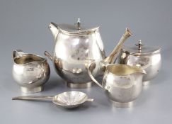 A stylish 1970's silver four piece tea set with tea strainer by Graham Watling of Lacock, of