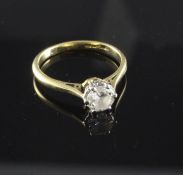 An 18ct gold and platinum, solitaire diamond ring, the round brilliant cut stone weighing