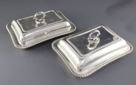 A pair of Edwardian silver entree dishes by William Hutton & Sons Ltd, of shaped rectangular form,