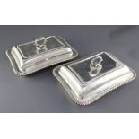 A pair of Edwardian silver entree dishes by William Hutton & Sons Ltd, of shaped rectangular form,