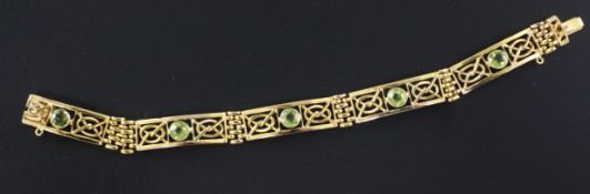An Edwardian 9ct gold and peridot set fancy link bracelet, 6.75in.