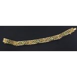 An Edwardian 9ct gold and peridot set fancy link bracelet, 6.75in.