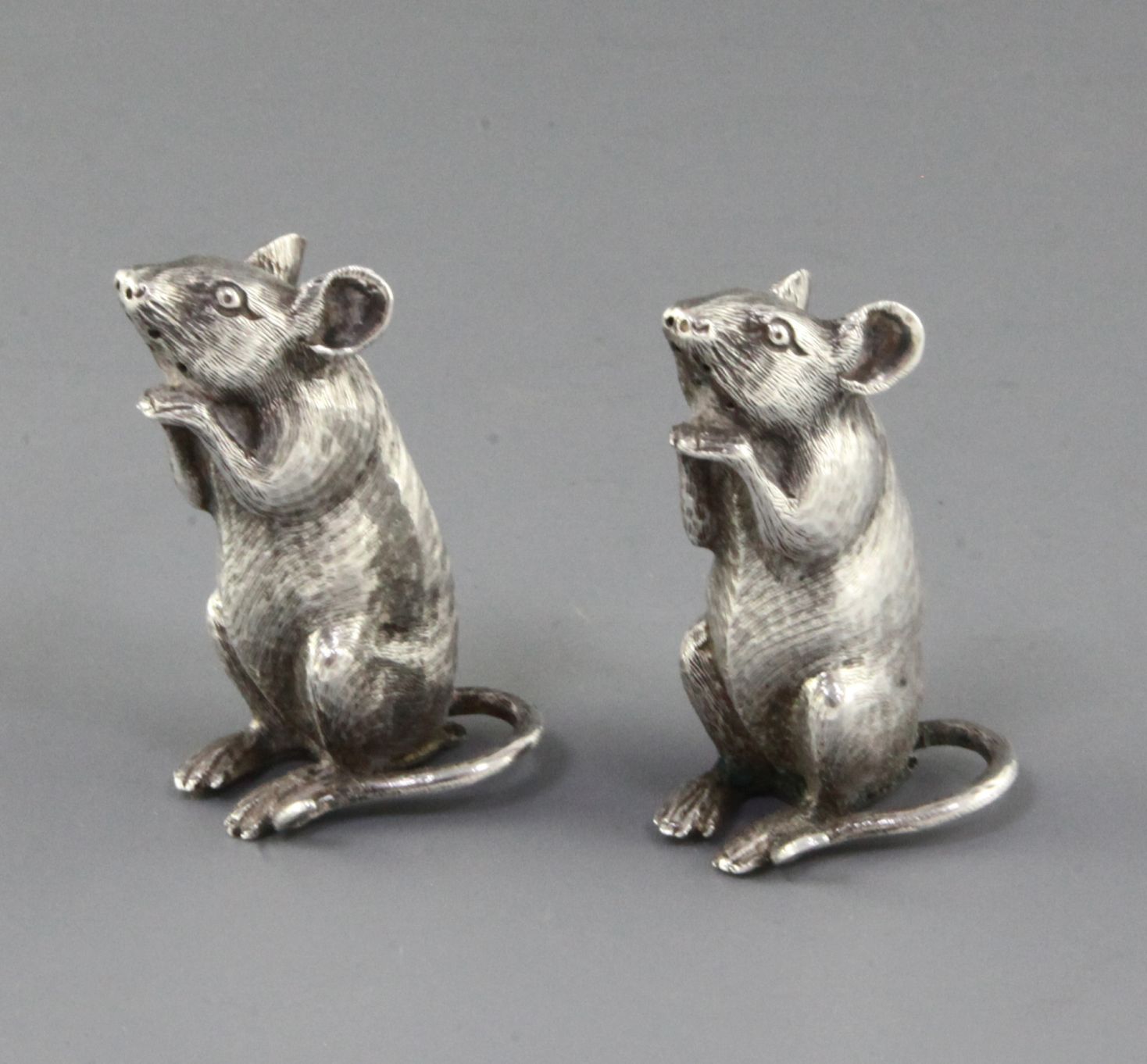 A pair of late Victorian novelty silver pepperettes by Saunders & Shepherd, each modelled as a