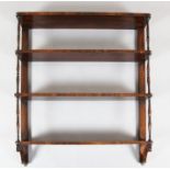 A Regency rosewood four tier wall shelf, with ring turned spindles, W.2ft 9in. D.6in. H.3ft 3in.