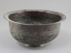 A 16th century Khorassan hammered copper bowl, engraved with scrolls and carnations, 9.75in.