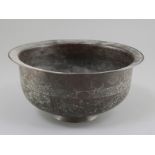 A 16th century Khorassan hammered copper bowl, engraved with scrolls and carnations, 9.75in.