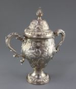 A George III silver two handled pedestal cup and cover by Edward Aldridge I, with later embossed