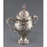 A George III silver two handled pedestal cup and cover by Edward Aldridge I, with later embossed