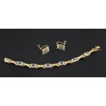 A gold and aquamarine bracelet set with seven emerald cut stones and a pair of similar 9ct earrings,