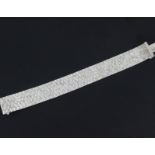 A 1970's bright cut engraved 9ct white gold bracelet, 7.25in.