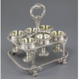 A George III silver egg cruet by William Elliott, of rectangular form, with six cups, engraved