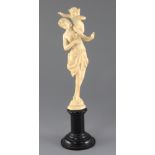 A 19th century French Dieppe ivory carving of Venus and Cupid, on an ebonised socle, Overall H.13.