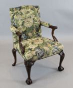 An Edwardian Georgian style mahogany Gainsborough chair, with foliate carved frame, on claw and ball