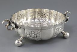 An Edwardian Carolean style textured silver circular fruit bowl, with scroll handles and embossed