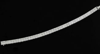 An attractive 18ct white gold and diamond line bracelet, set with baguette and round cut diamonds