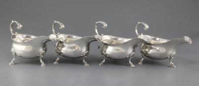 A set of four George III silver sauceboats by Thomas Shepherd, with cut cusped borders, engraved