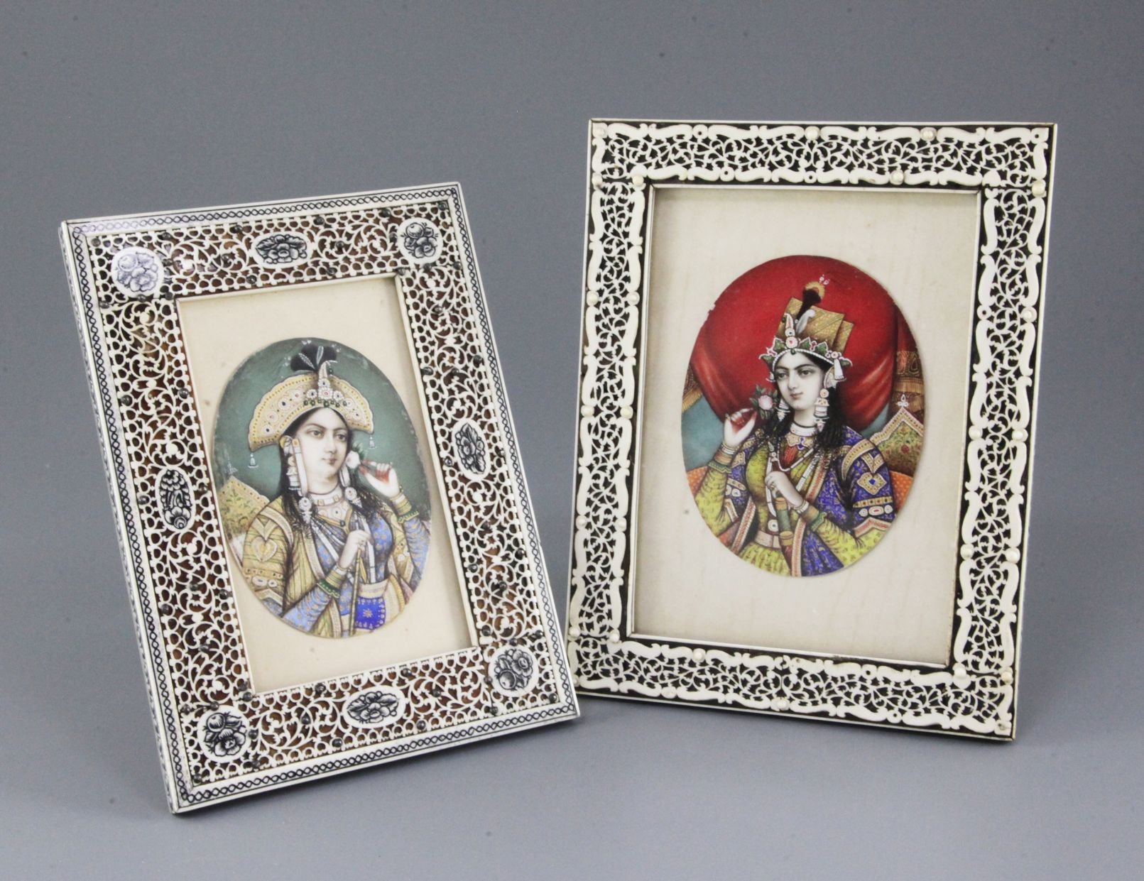 A near pair of late 19th century Indian gouache on ivory miniatures of Mughal consorts,