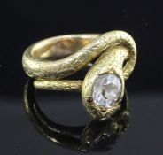 An early 20th century Indian gold and solitaire diamond serpent ring, set with cushion cut stone and
