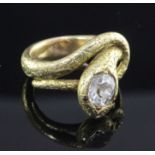 An early 20th century Indian gold and solitaire diamond serpent ring, set with cushion cut stone and