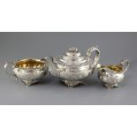 A George IV silver three piece tea set by Richard Pearce & George Burrows, of circular form, with