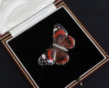 An early 20th century gold, ruby and diamond set enamelled butterfly brooch, modelled as a Red