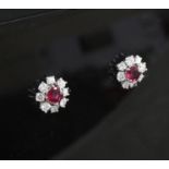A pair of white gold ruby and diamond cluster ear studs, with a total ruby weight of 0.66cts, 10mm.