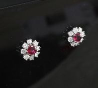 A pair of white gold ruby and diamond cluster ear studs, with a total ruby weight of 0.66cts, 10mm.