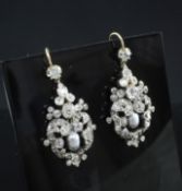 A pair of Victorian gold and silver, diamond and pearl cluster drop earrings, of pierced scrolling