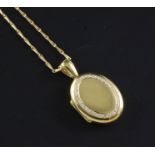 A 1990's Mappin & Webb 18ct gold and diamond oval locket on an 18ct gold chain, locket 1.25in inc.