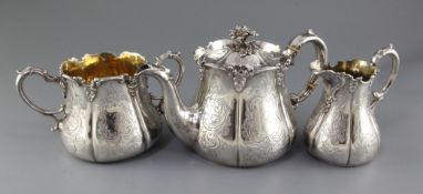 A Victorian three piece silver tea set by Henry Wilkinson & Co, of baluster form and engraved with