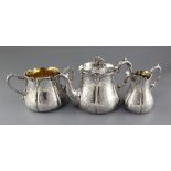 A Victorian three piece silver tea set by Henry Wilkinson & Co, of baluster form and engraved with