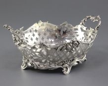 An antique Dutch? pierced silver two handled dish, of oval form with floral and scrolling
