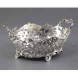 An antique Dutch? pierced silver two handled dish, of oval form with floral and scrolling
