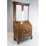 An early 18th century walnut bureau bookcase, with two glazed doors over a fall enclosing a well,