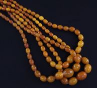 Three single strand graduated oval yellow amber bead necklaces, two with metal clasps, gross 102