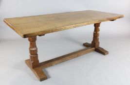 A Robert 'Mouseman' Thompson oak refectory table, with rounded rectangular top on octagonal end