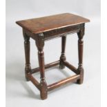 A 17th century oak joynt stool, incised with the initials 'W. R.' 1ft. 7in. H.1ft 9in.