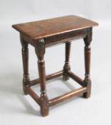 A 17th century oak joynt stool, incised with the initials 'W. R.' 1ft. 7in. H.1ft 9in.