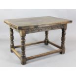 A 17th century style oak draw leaf table, with scroll carved frieze and squared stretchers, W.4ft