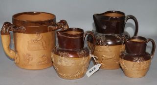 A Doulton stoneware 3-handled loving cup and 3 graduated Lambeth stoneware jugs, some damage