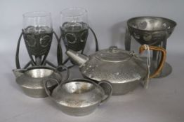 An Archibold Knox - a Tudric pewter stand & pair of vase holders & 3 piece Tudric teaset