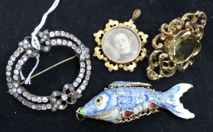 Two brooches, an enamelled articulated fish and a paste brooch.