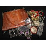 A snakeskin evening bag and various items of costume jewellery.