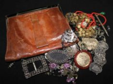 A snakeskin evening bag and various items of costume jewellery.