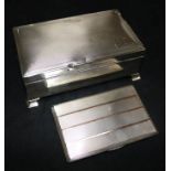 A silver cigarette case and a silver cigarette box.